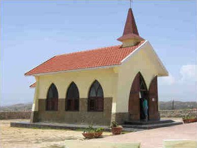 The small yellow Alto Vista Chapel on a hill in northern Aruba