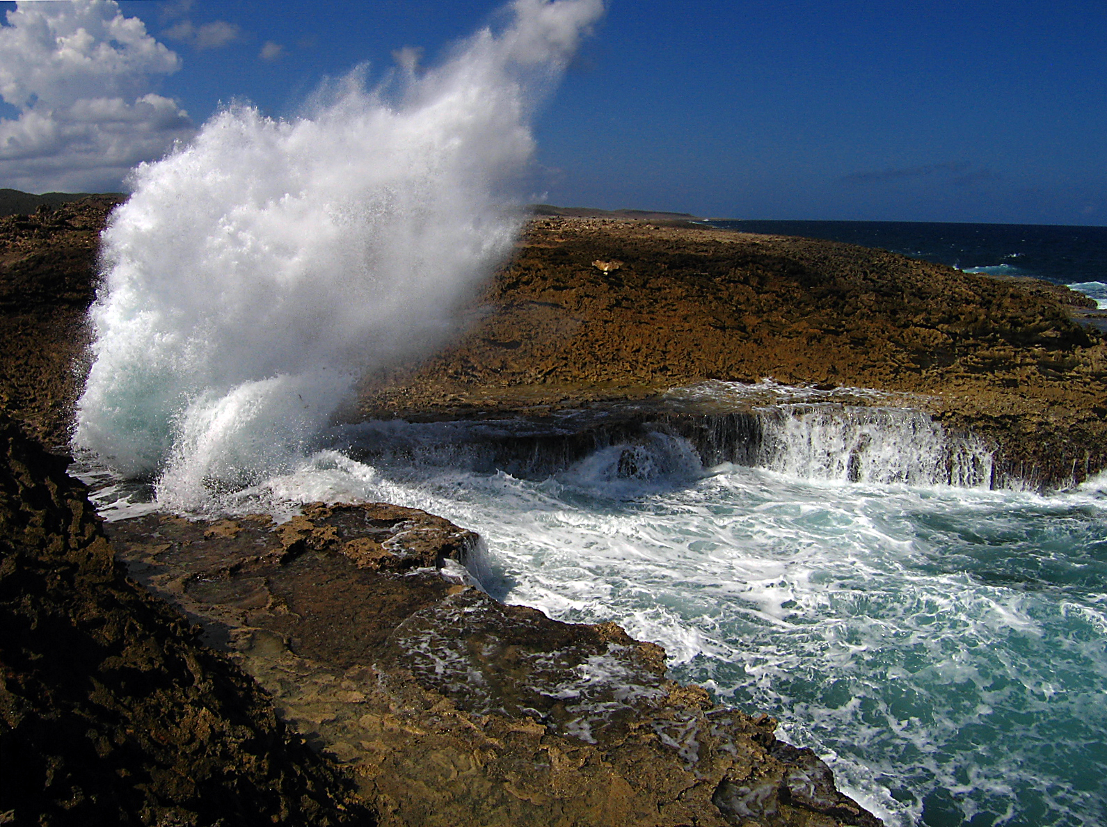 Waves crashing through a rock blowhole at Boka Pistol in Shete Boka National Park, Curaçao