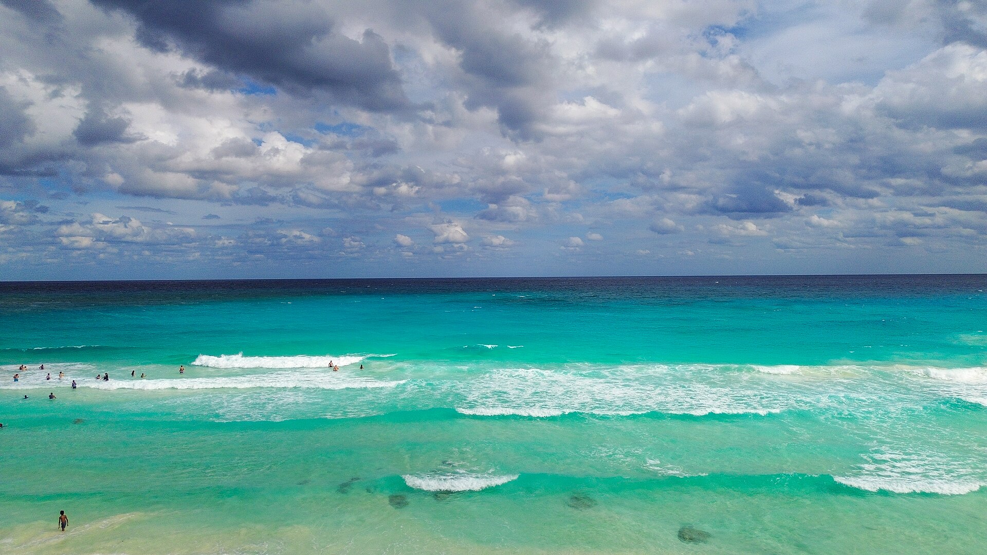 Cancún coastline with turquoise Caribbean water and white sand beach