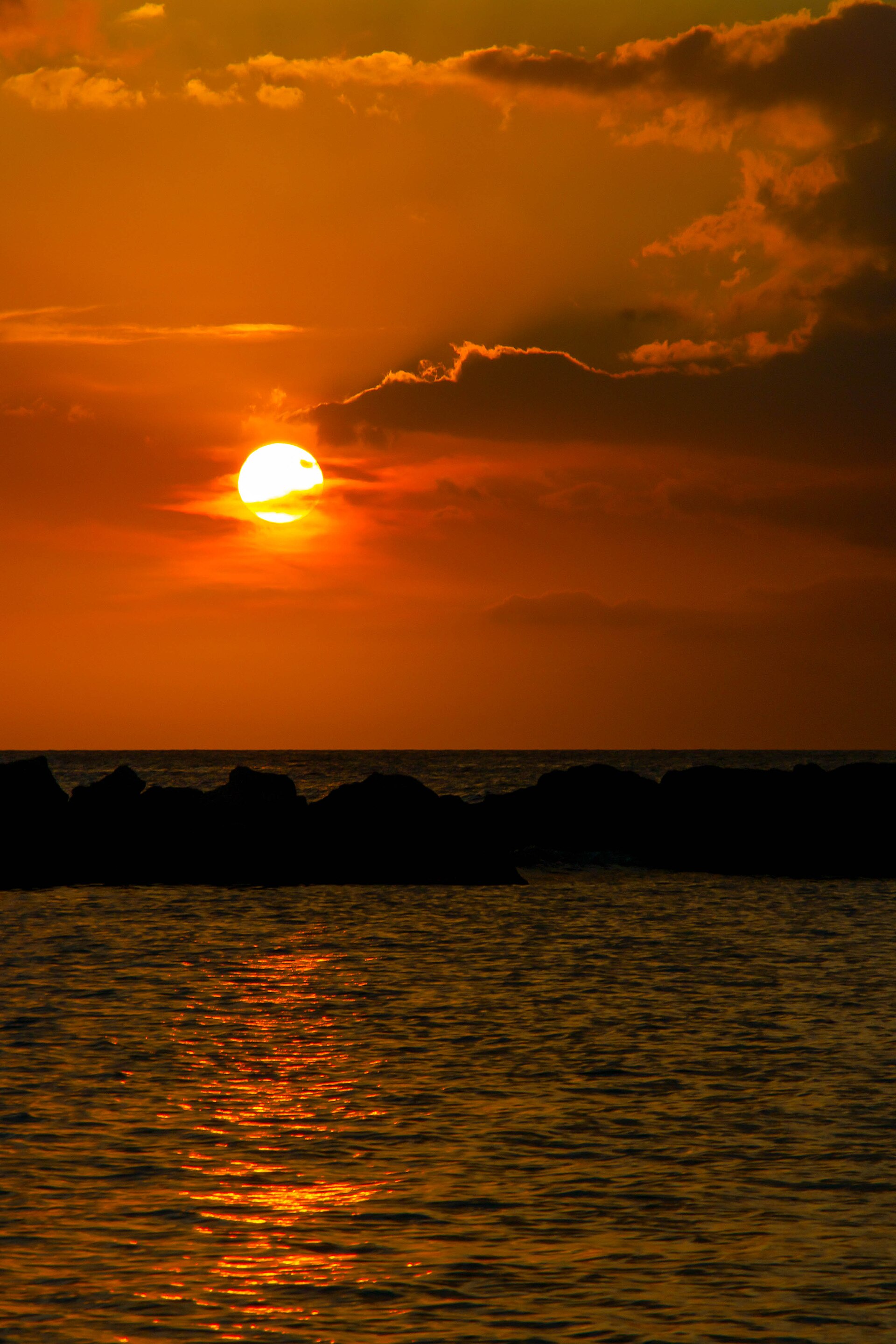 Sunset over Mambo Beach, a lively beach club stretch near Jan Thiel, Curaçao