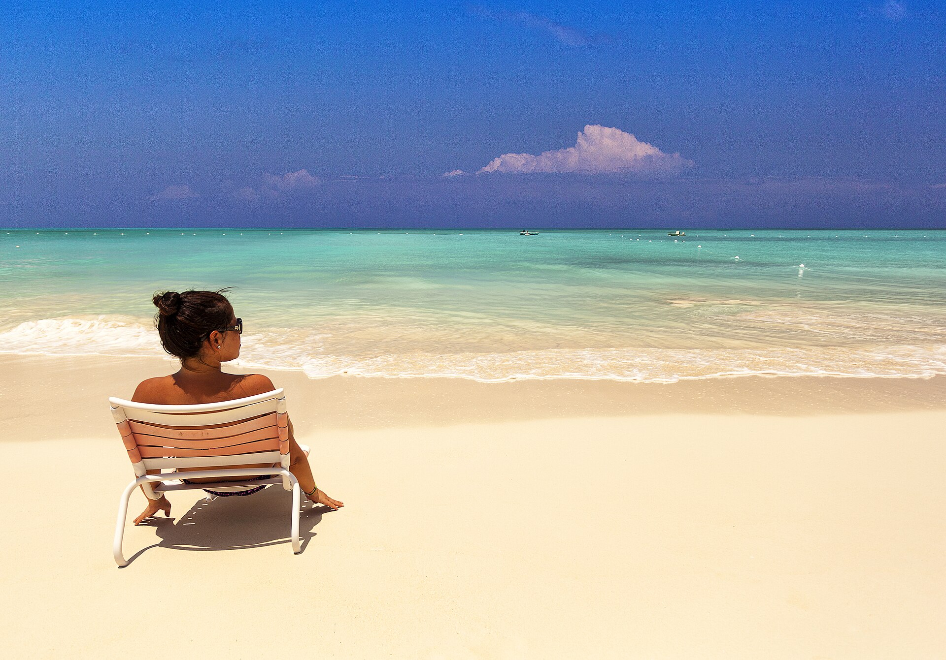 Pale turquoise shallows meeting white sand on a Turks and Caicos beach